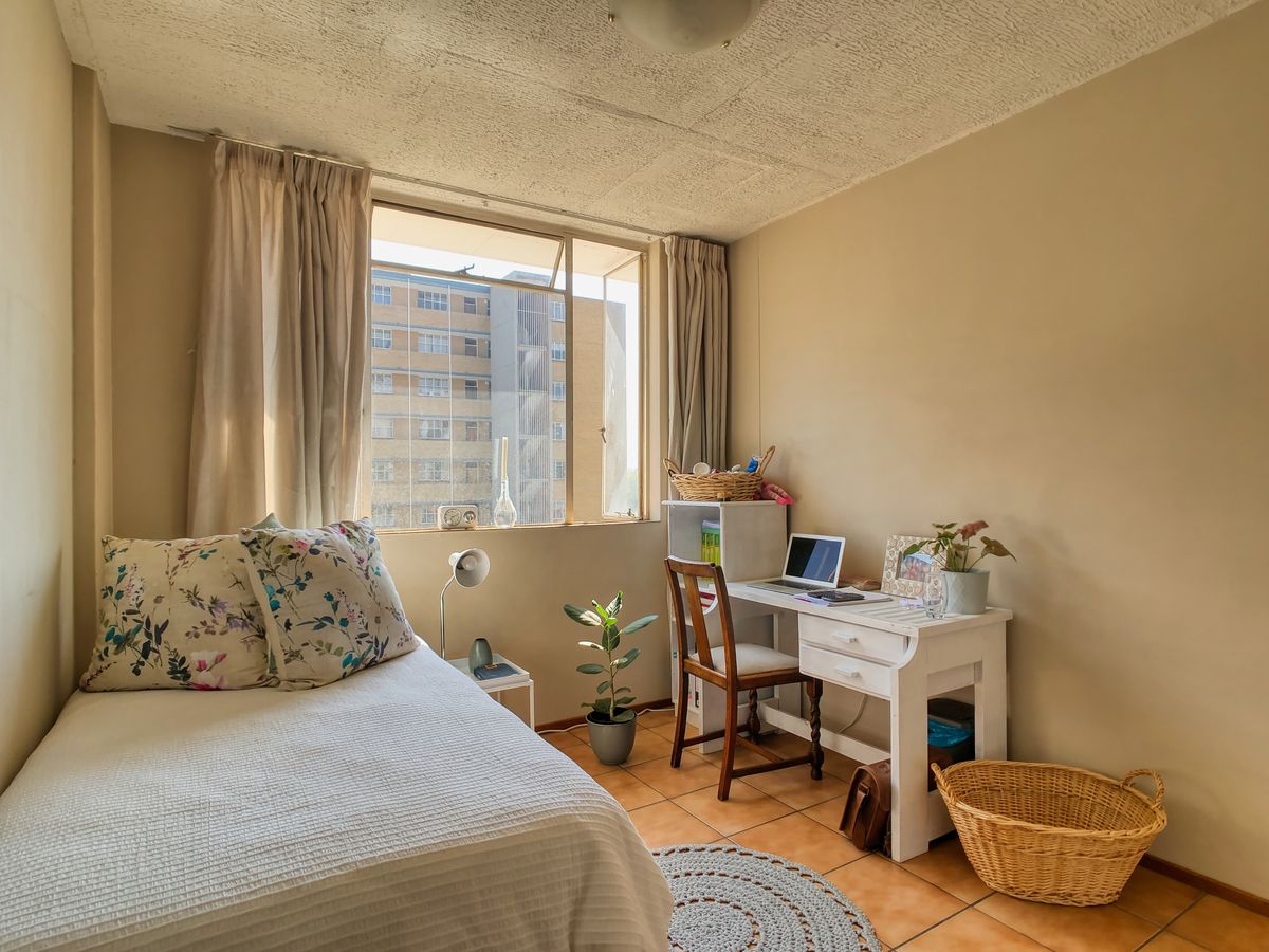 A clean and warm student room with study desk